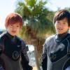 two male diver wearing dry suit