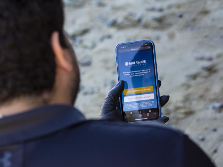 a man holding his phone opening an app