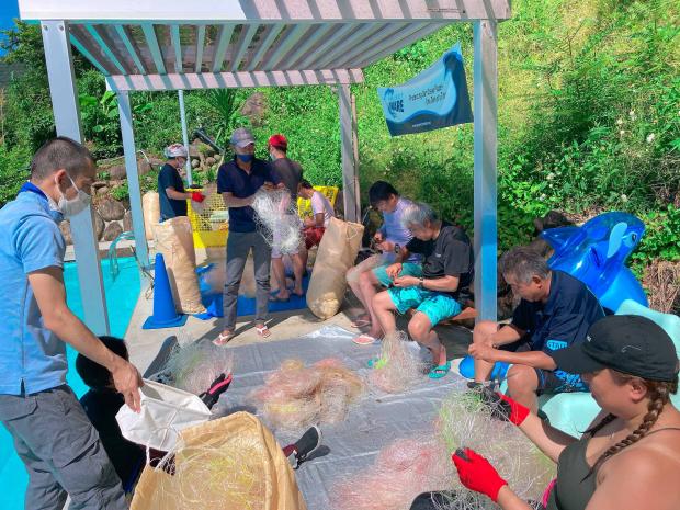 a group of divers with collected fishing nets